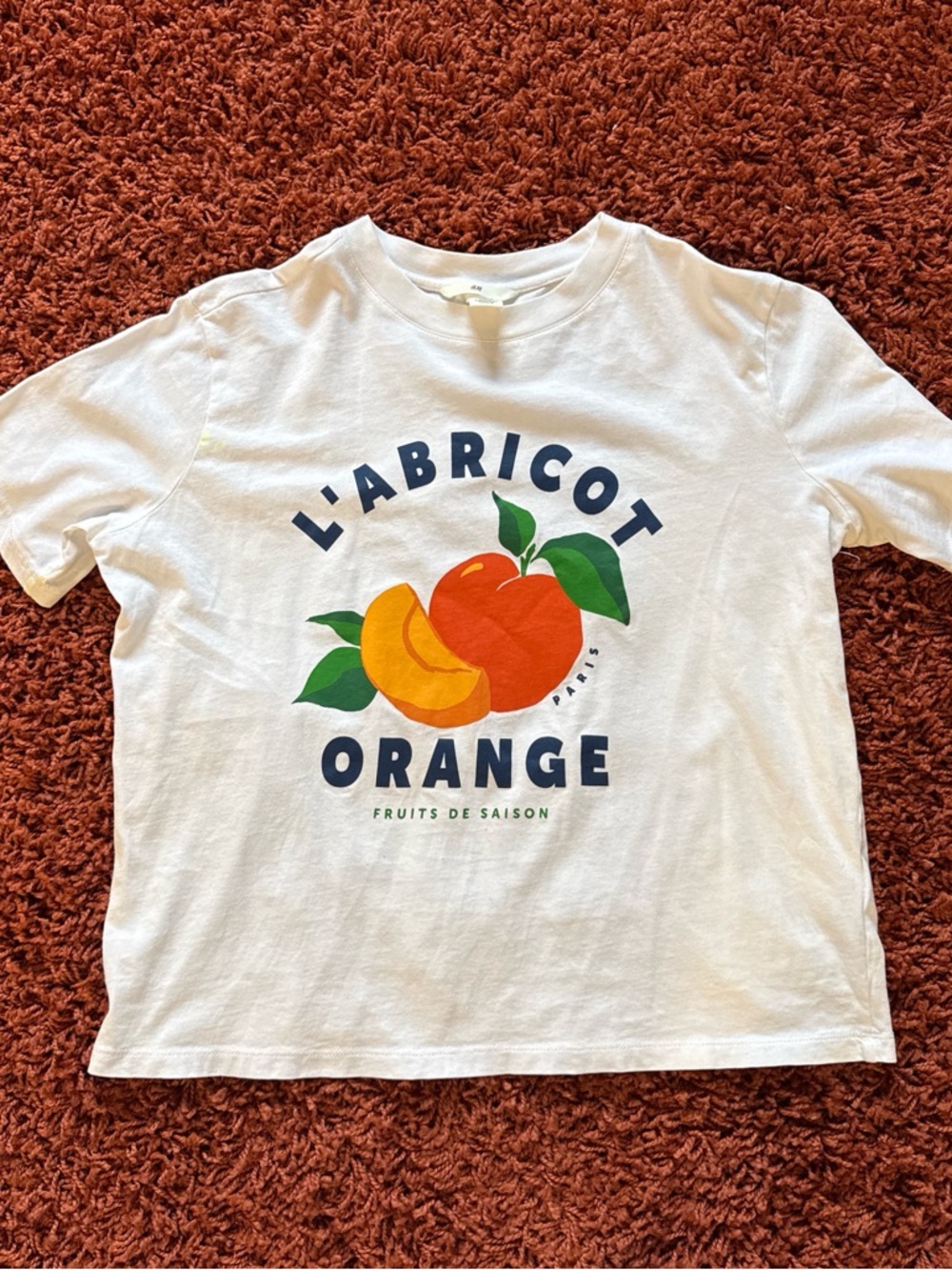 White Graphic Tee with Orange Apricot Design